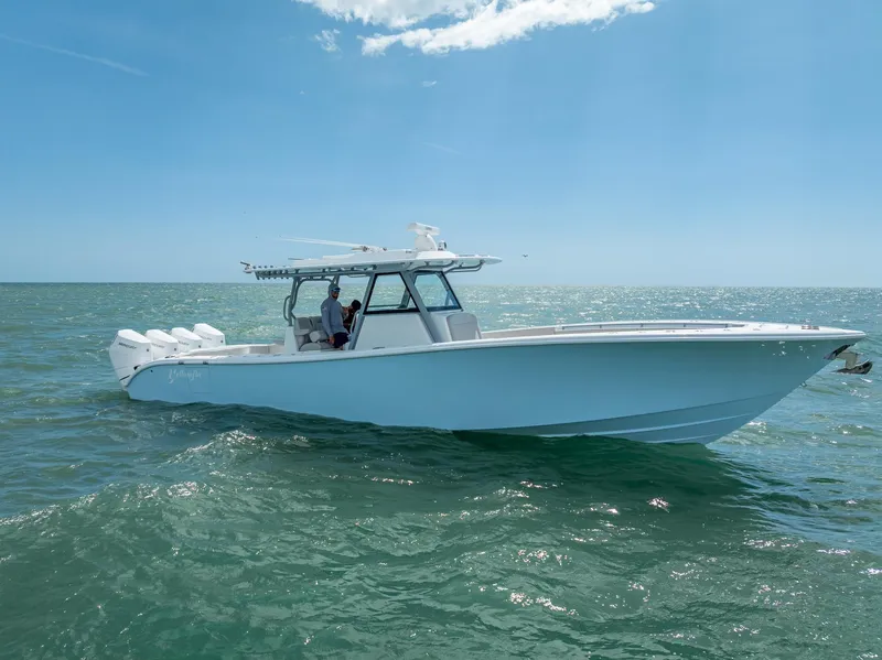 Slide: The Image of 2024 Yellowfin 39 boat cruising on open water under clear blue sky. - 5