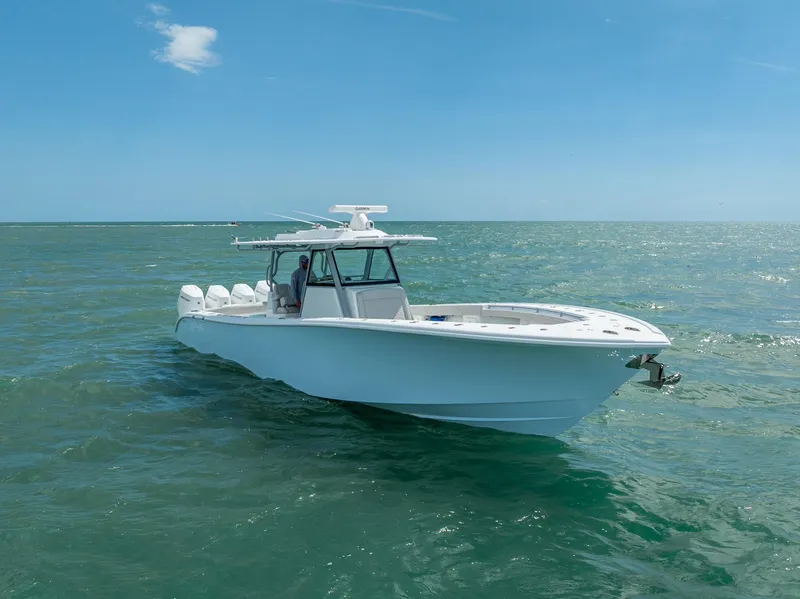 Slide: The Image of 2024 Yellowfin 39 boat cruising on open sea under clear blue sky. - 6