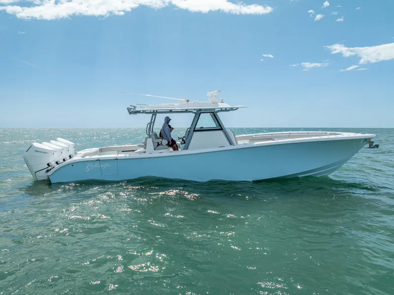 Slide: The Image of 2024 Yellowfin 39 boat cruising on open water under clear skies. - 8
