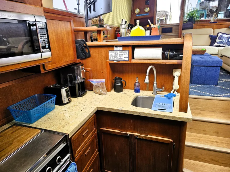 Slide: The Image of 1984 Uniflite 42 Double Cabin kitchen with wooden cabinetry and modern appliances. - 12