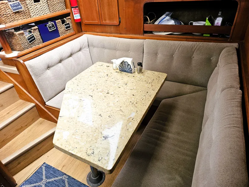 Slide: The Image of 1984 Uniflite 42 Double Cabin interior with cushioned seating and a marble table. - 13