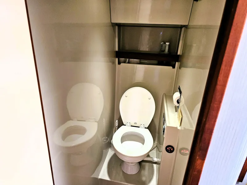 Slide: The Image of 1984 Uniflite 42 Double Cabin bathroom with toilet and shelf. - 17
