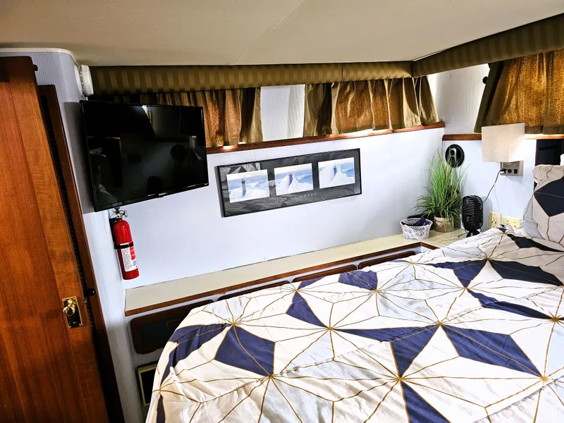 Slide: The Image of 1984 Uniflite 42 Double Cabin interior with bed, TV, and decor elements. - 24