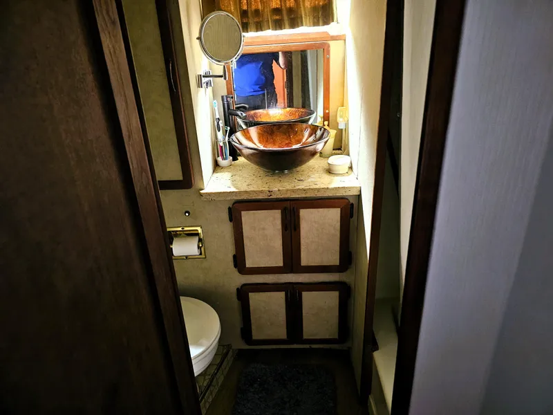 Slide: The Image of 1984 Uniflite 42 Double Cabin bathroom with vessel sink and wooden cabinetry. - 25