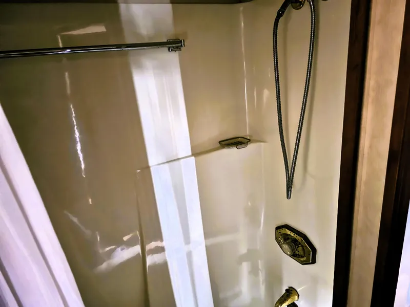 Slide: The Image of Shower area in 1984 Uniflite 42 Double Cabin yacht with chrome fixtures. - 26