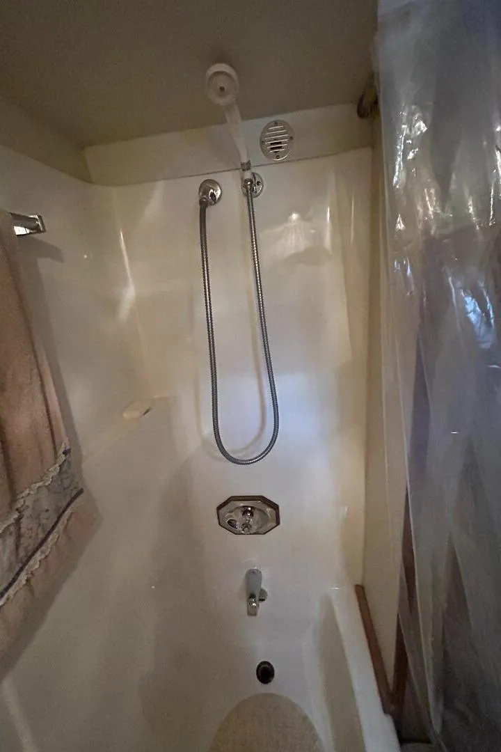 Slide: The Image of 1984 Uniflite 42 Double Cabin shower with handheld showerhead and curtain. - 27
