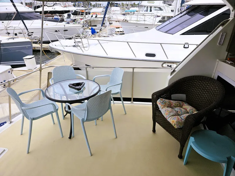 Slide: The Image of 1984 Uniflite 42 Double Cabin yacht with outdoor seating area in marina. - 3