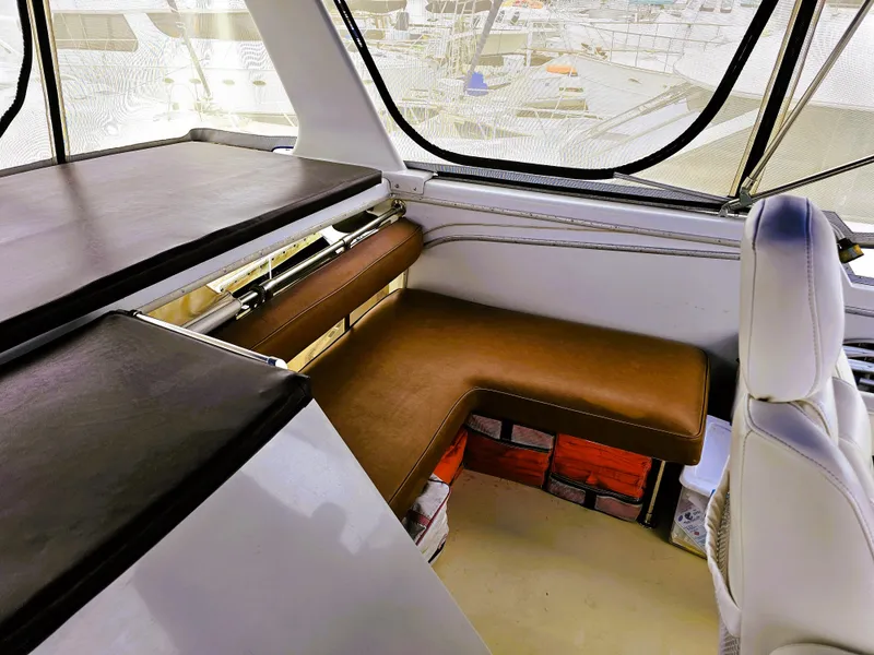 Slide: The Image of 1984 Uniflite 42 Double Cabin interior with brown seating and storage compartments. - 30