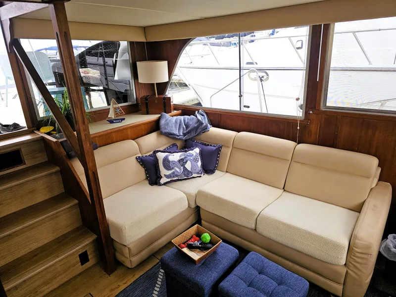 Slide: The Image of 1984 Uniflite 42 Double Cabin interior with beige sofa and nautical decor. - 5