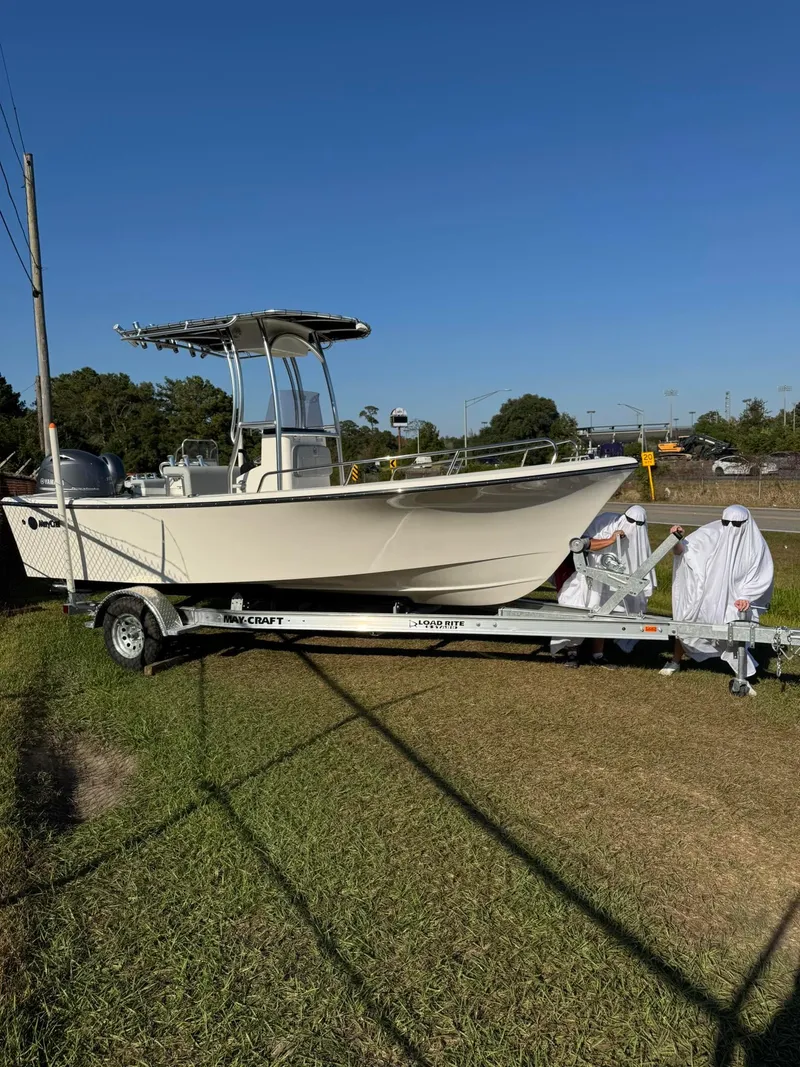 Slide: The Image of 2024 May-Craft 1900CC boat on trailer, outdoors, with people in white suits. - 20