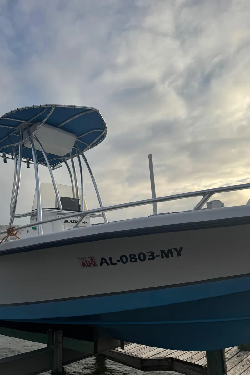 Slide: The Image of 2017 Blazer Bay 1900 boat docked under cloudy sky. - 9