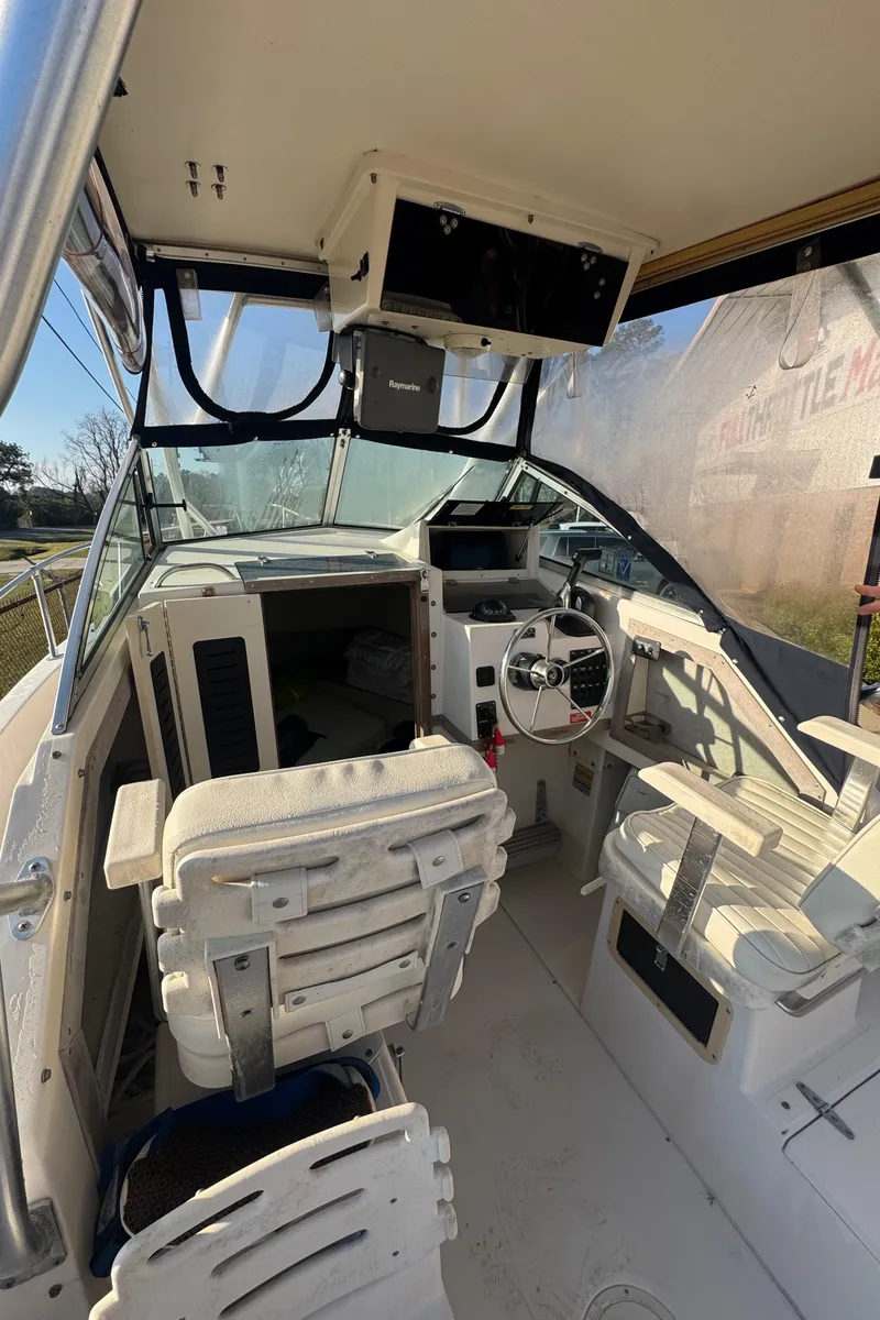 Slide: The Image of 1993 Grady-White Seafarer 22 boat interior with steering wheel and seating. - 10