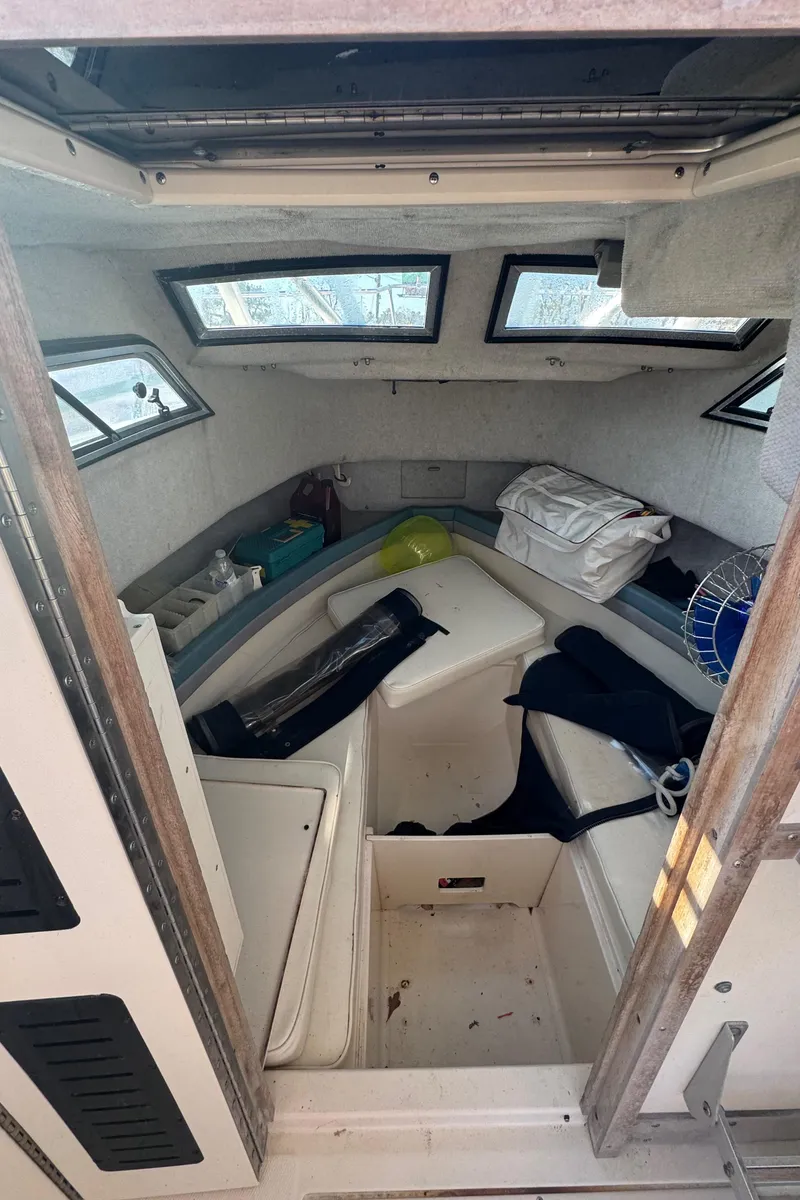 Slide: The Image of 1993 Grady-White Seafarer 22 cabin interior with seating and storage. - 11