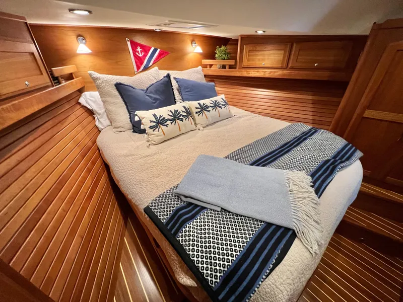 Slide: The Image of Cozy cabin interior of 2017 Sabre 48 Salon Express with elegant bedding and wooden paneling. - 17
