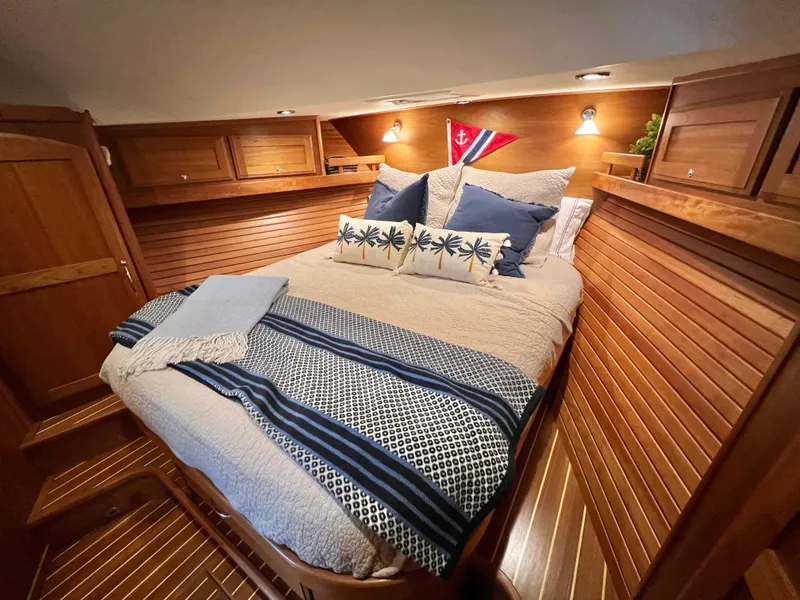 Slide: The Image of Cozy bedroom in 2017 Sabre 48 Salon Express yacht with nautical decor and wood paneling. - 18