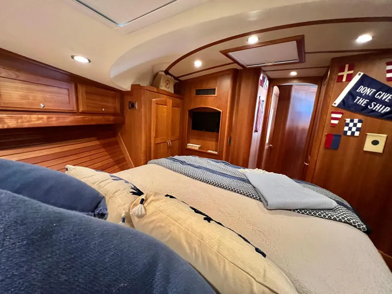 Slide: The Image of Luxurious cabin interior of 2017 Sabre 48 Salon Express yacht with cozy bedding and wooden finishes. - 49