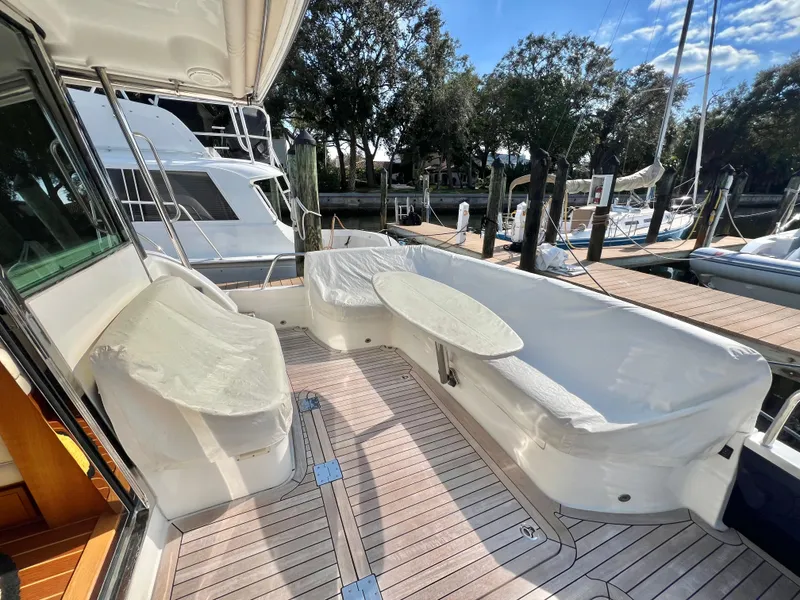 Slide: The Image of 2017 Sabre 48 Salon Express yacht with spacious outdoor seating and table on deck. - 7