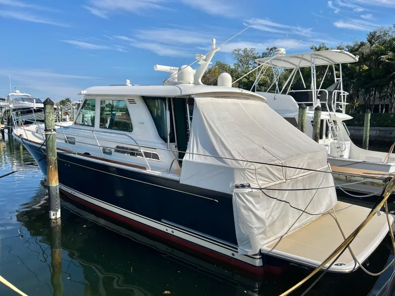 Slide: The Image of 2017 Sabre 48 Salon Express yacht docked at marina under clear blue sky. - 9
