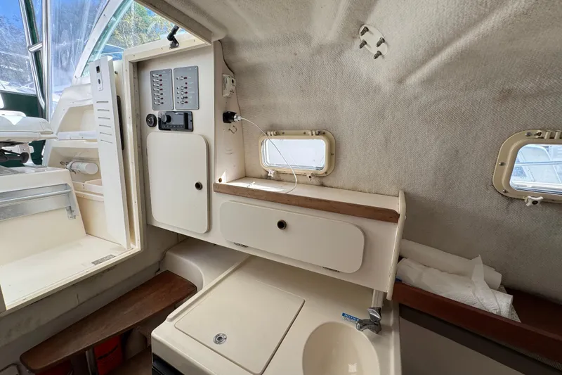 Slide: The Image of Interior of a 1998 Pursuit 2800 Walkaround boat with control panel and sink. - 15