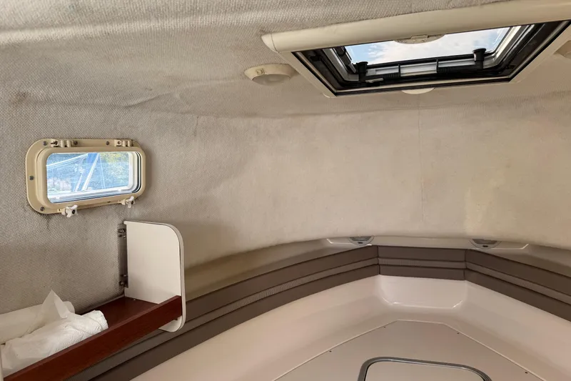 Slide: The Image of Interior cabin of a 1998 Pursuit 2800 Walkaround boat with window and hatch. - 16