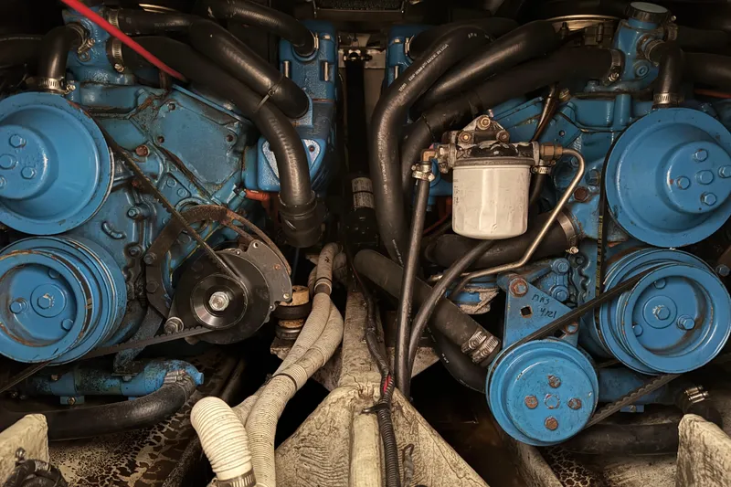 Slide: The Image of Twin blue engines in a 1998 Pursuit 2800 Walkaround boat, showcasing mechanical components. - 21
