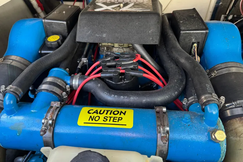 Slide: The Image of Engine of a 1998 Pursuit 2800 Walkaround boat with "Caution No Step" label. - 22