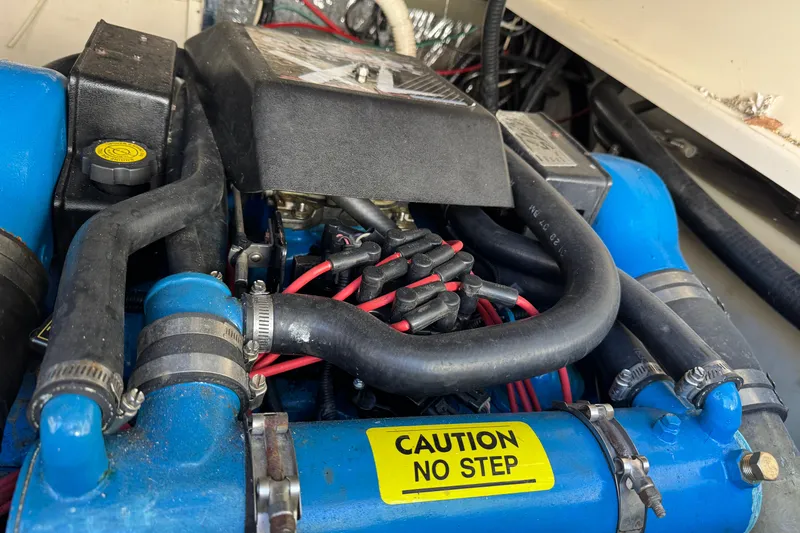 Slide: The Image of Engine compartment of a 1998 Pursuit 2800 Walkaround with "Caution No Step" label. - 23