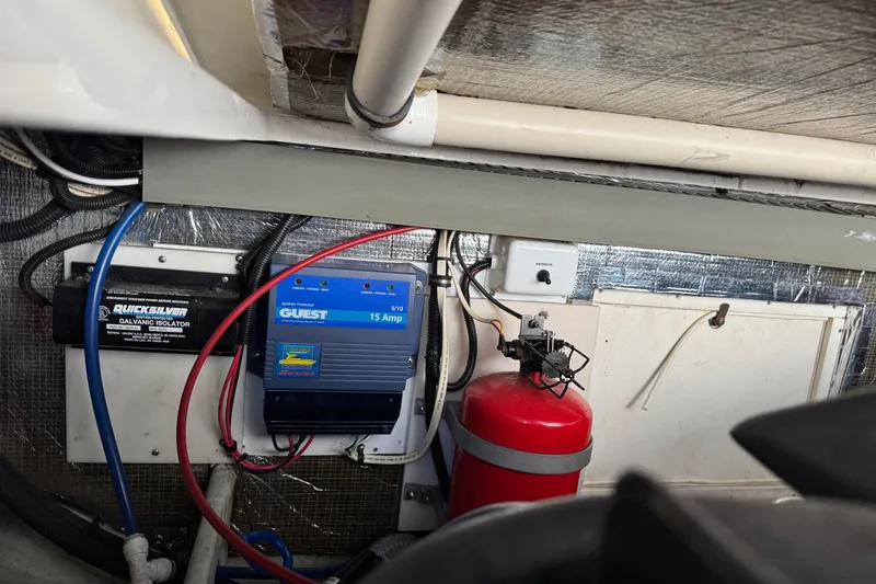Slide: The Image of Electrical components and fire extinguisher in 1998 Pursuit 2800 Walkaround boat interior. - 26