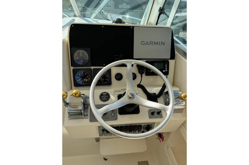 Slide: The Image of 1998 Pursuit 2800 Walkaround helm with Garmin navigation and control instruments. - 6