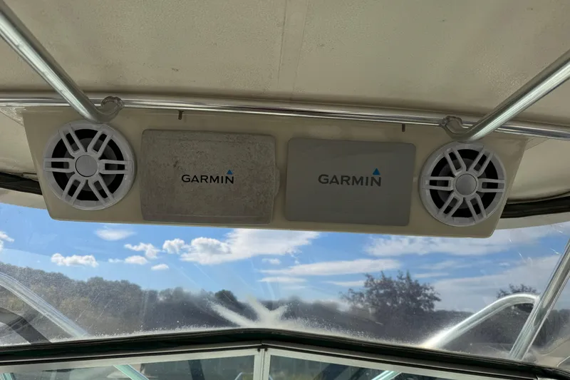 Slide: The Image of Garmin speakers and equipment on 1998 Pursuit 2800 Walkaround boat, clear sky background. - 7