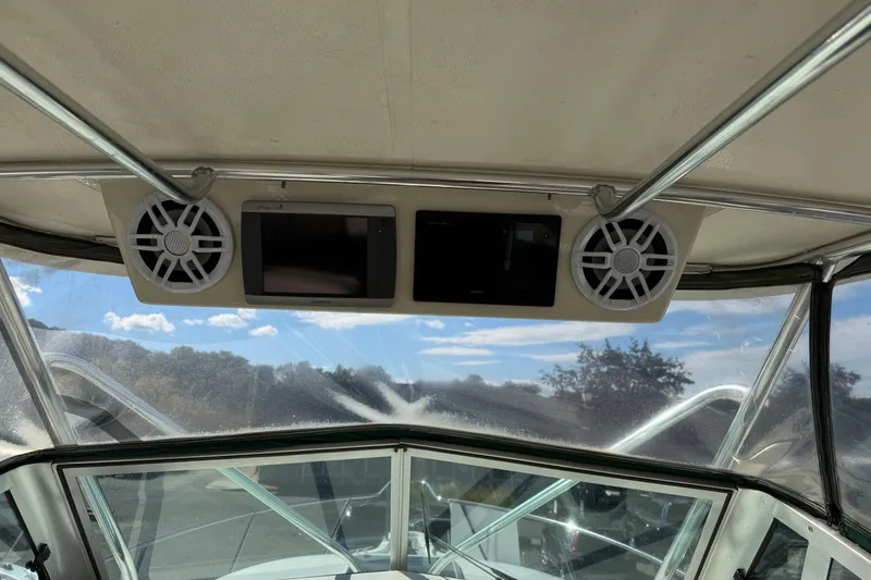 Slide: The Image of Interior view of a 1998 Pursuit 2800 Walkaround boat with speakers and navigation screens. - 8