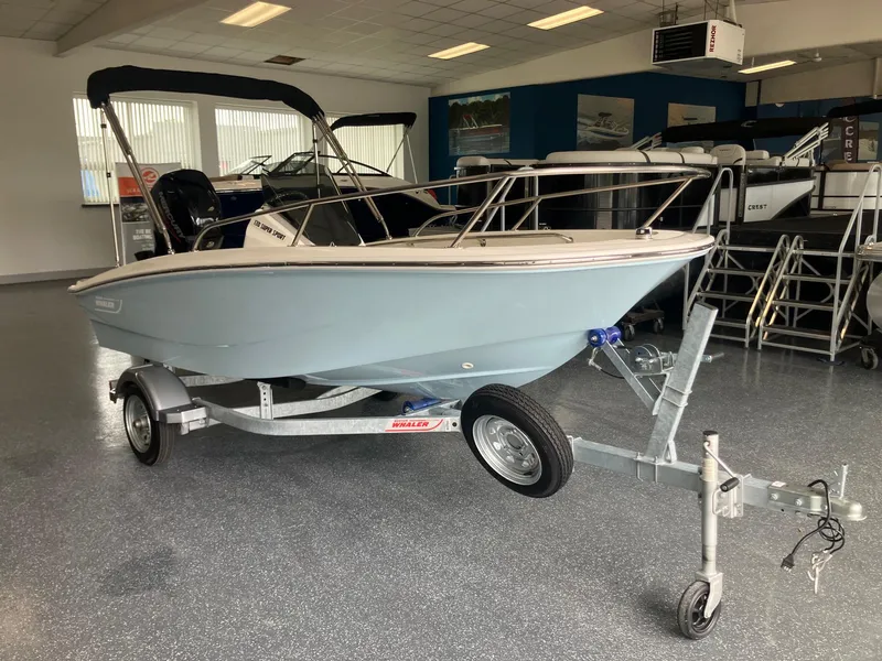 The Image of 2025 Boston Whaler 130 Super Sport boat on trailer in showroom. - 0