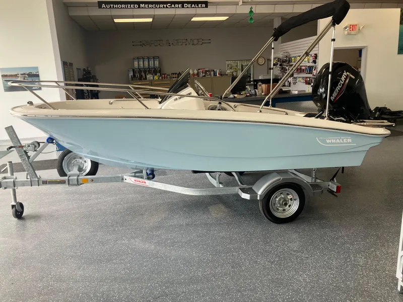 Slide: The Image of 2025 Boston Whaler 130 Super Sport boat on trailer in showroom. - 3