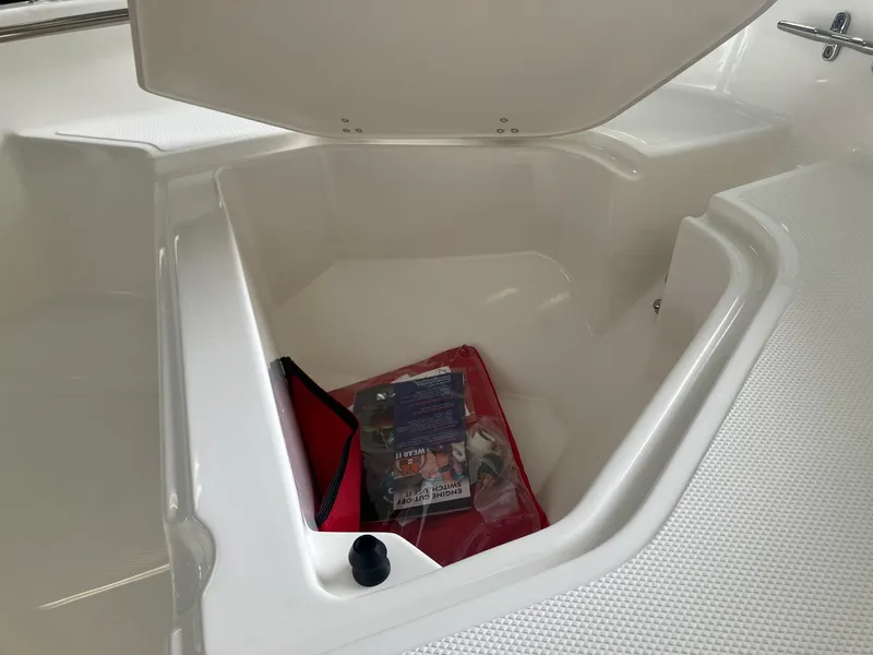 Slide: The Image of Open storage compartment in 2025 Boston Whaler 130 Super Sport boat. - 8