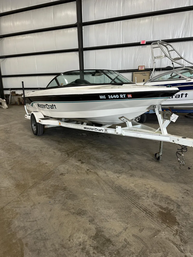Slide: The Image of 1998 MasterCraft Pro Star 190 boat on trailer in indoor storage facility. - 4
