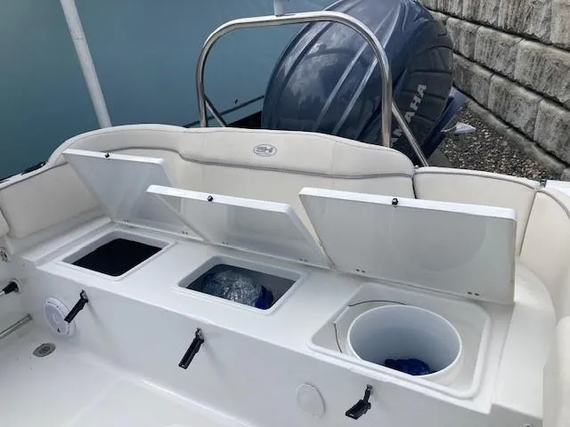 Slide: The Image of 2024 Sea Hunt Ultra 229 boat interior with storage compartments open. - 13