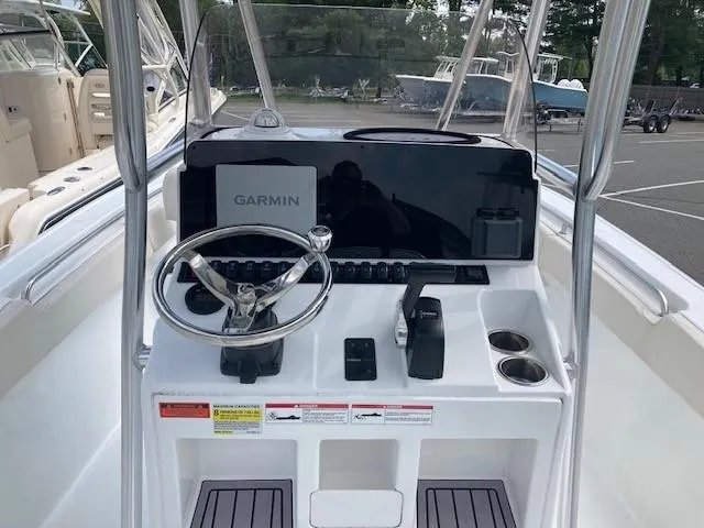Slide: The Image of 2024 Sea Hunt Ultra 229 boat console with Garmin navigation system and steering wheel. - 4
