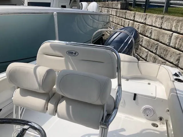 Slide: The Image of 2024 Sea Hunt Ultra 229 boat interior with white seating and sleek design. - 5