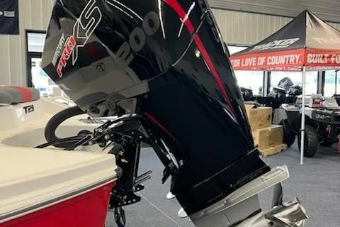 Slide: The Image of 2025 Tahoe T21 boat with powerful outboard motor in showroom setting. - 3