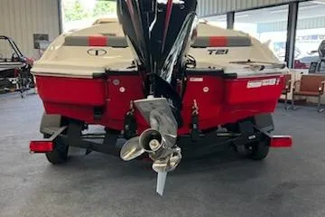 Slide: The Image of 2025 Tahoe T21 boat, rear view, in a showroom with visible propeller. - 78