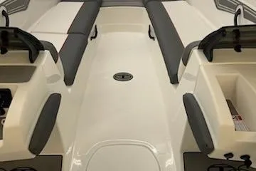 Slide: The Image of 2025 Tahoe T21 boat interior with gray seating and storage compartments. - 92