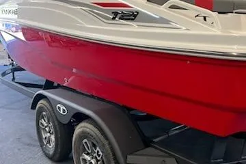 Slide: The Image of 2025 Tahoe T21 boat on trailer, red and white design, side view. - 95