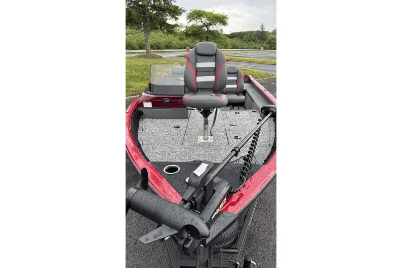 The Image of 2025 Ranger VS1682SC Reata fishing boat with red and gray seating, parked outdoors. - 0