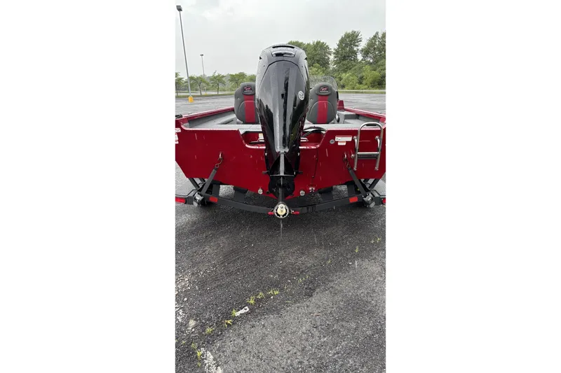 Slide: The Image of 2025 Ranger VS1682SC Reata boat, rear view with motor, parked on asphalt. - 3