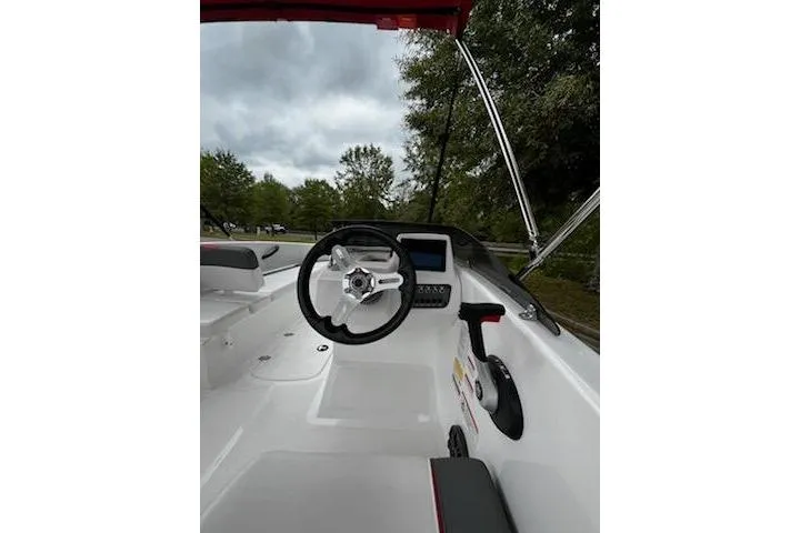 Slide: The Image of 2025 Tahoe T16 boat cockpit with steering wheel and control panel, set against a cloudy sky. - 9