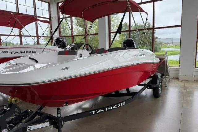 Slide: The Image of 2025 Tahoe T16 boat with red and white design, displayed indoors on a trailer. - 1