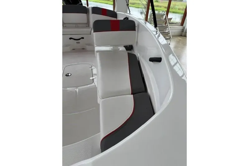 Slide: The Image of 2025 Tahoe T16 boat interior with white and gray seating, red accents, and sleek design. - 13