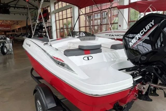 Slide: The Image of 2025 Tahoe T16 boat with Mercury engine, displayed indoors on a trailer. - 3