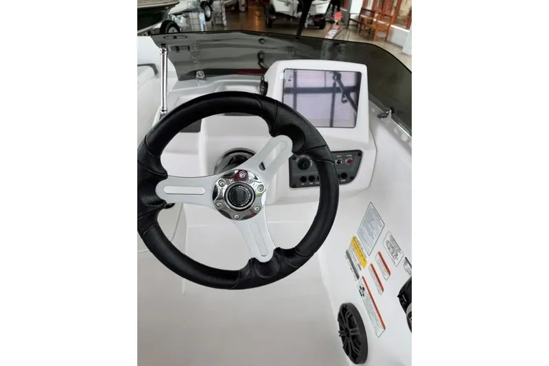 Slide: The Image of Steering wheel and dashboard of 2025 Tahoe T16 boat, featuring modern controls and display. - 7