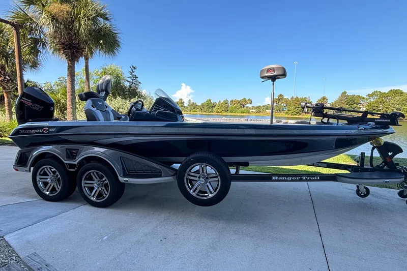 The Image of 2025 Ranger Z520R Cup-Equipped boat on trailer, parked near a scenic lake. - 0